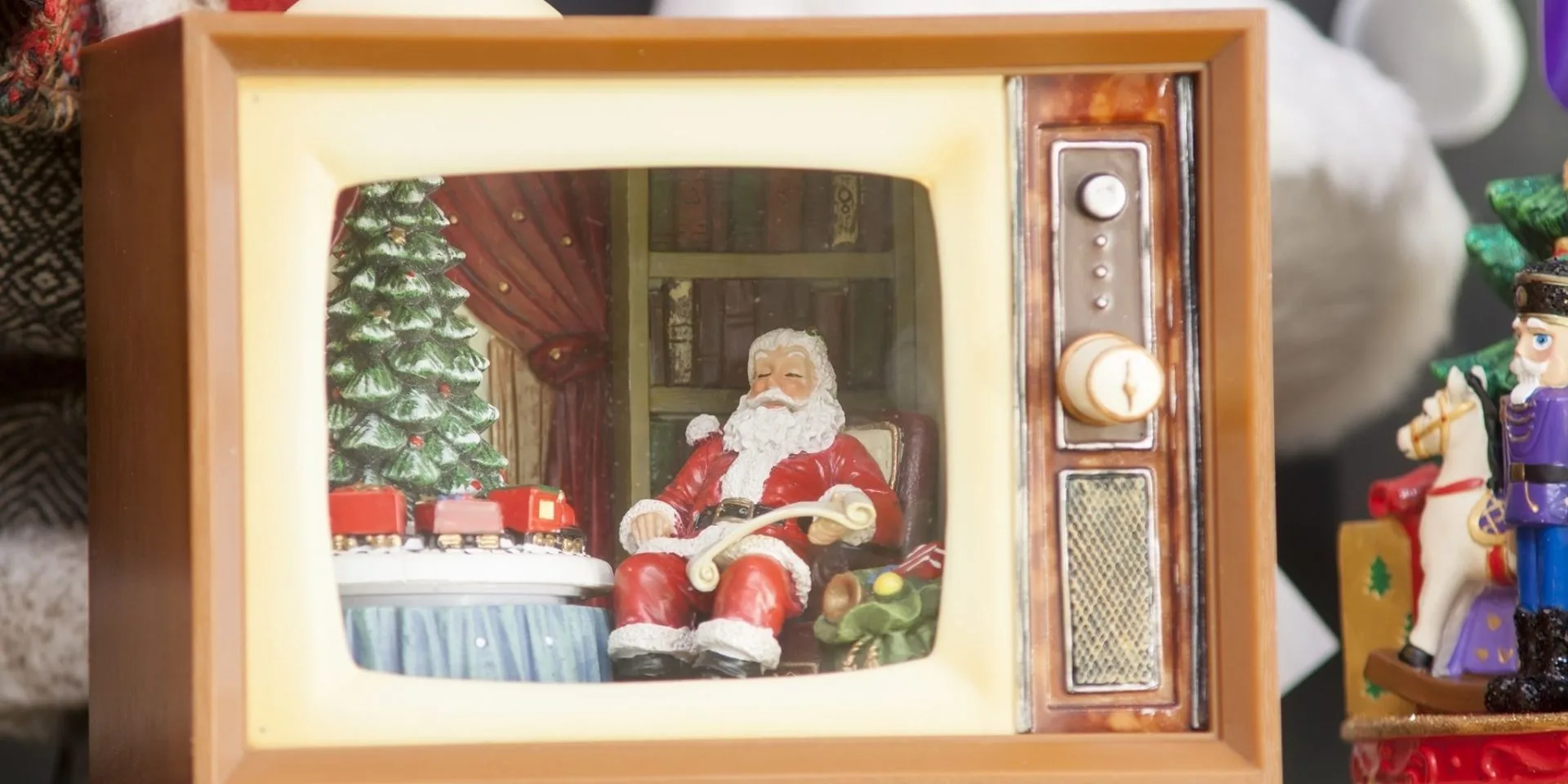 A toy Santa sat in a toy 80s style telly