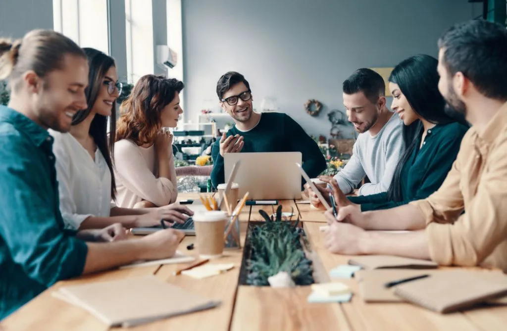 a marketing team meets around a table