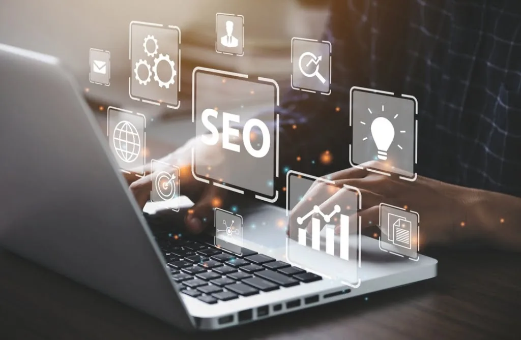A laptop, stylised with floating images depicting SEO