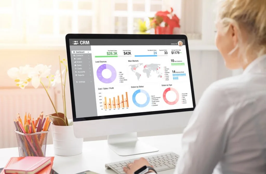 A small business owner reviewing her digital marketing strategy on a laptop