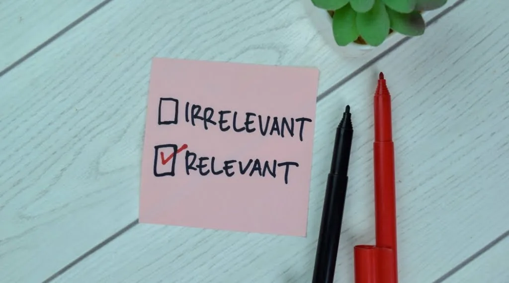 A post it note with two tick boxes next to the words 'irrelevant' and 'relevant.' Relevant is ticked.