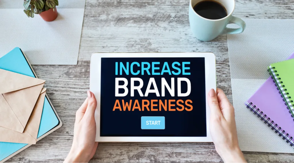 A tablet reads 'increase brand awareness.'